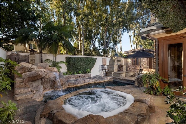 view of patio / terrace featuring a jacuzzi