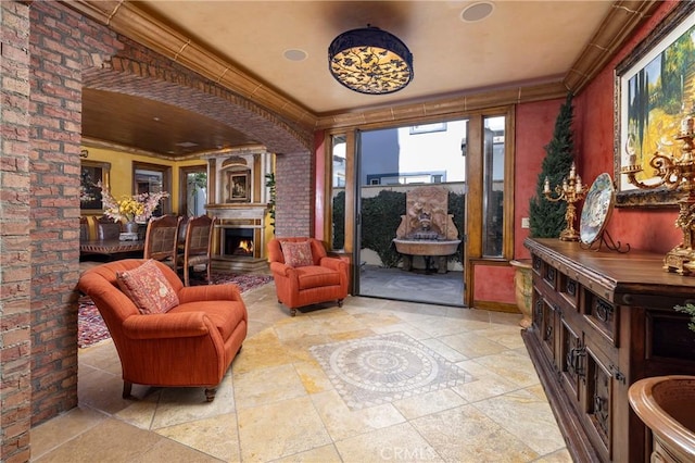 sitting room featuring crown molding and brick wall