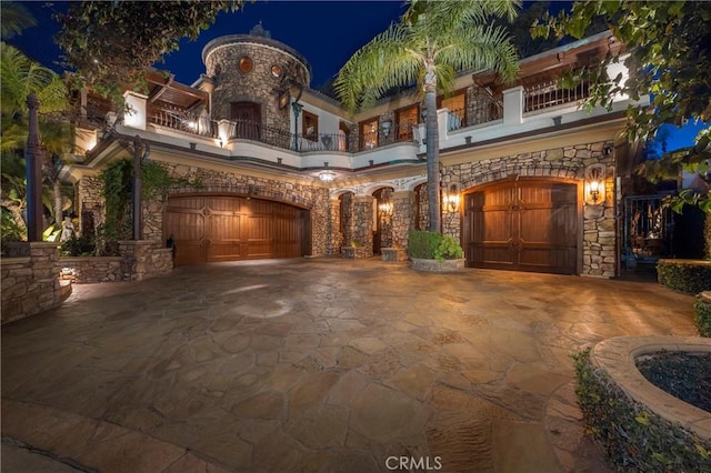 view of front of house with a garage and a balcony