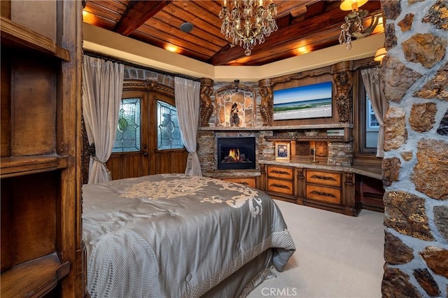 carpeted bedroom with a fireplace, wooden ceiling, a chandelier, and beamed ceiling