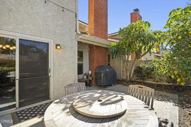 deck with area for grilling and a patio area