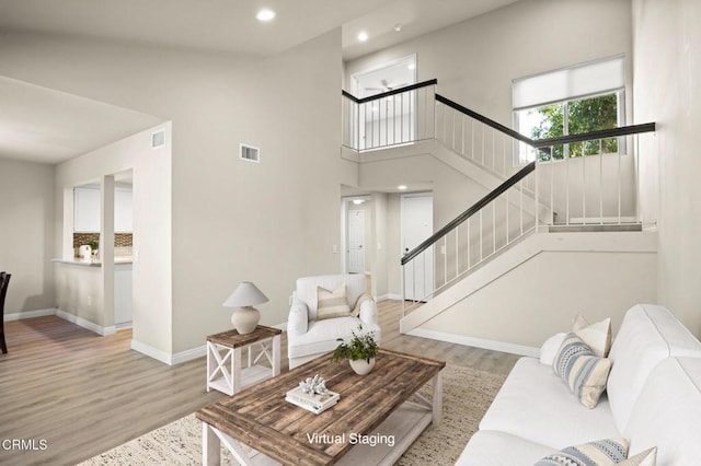 living room featuring hardwood / wood-style floors and a high ceiling