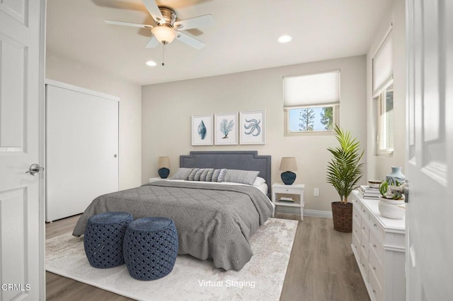 bedroom featuring ceiling fan and dark hardwood / wood-style flooring