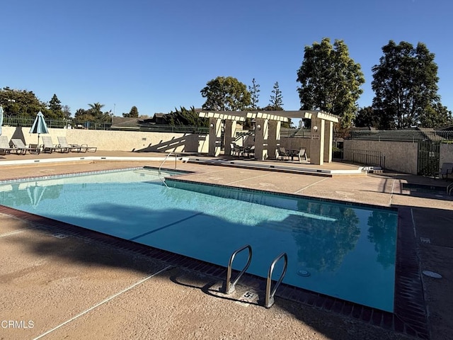 view of pool with a pergola and a patio area