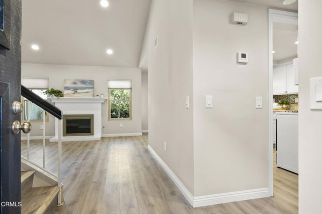 foyer featuring lofted ceiling and light wood-type flooring