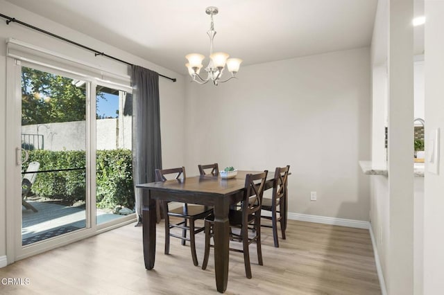 dining space featuring a chandelier and light wood-type flooring