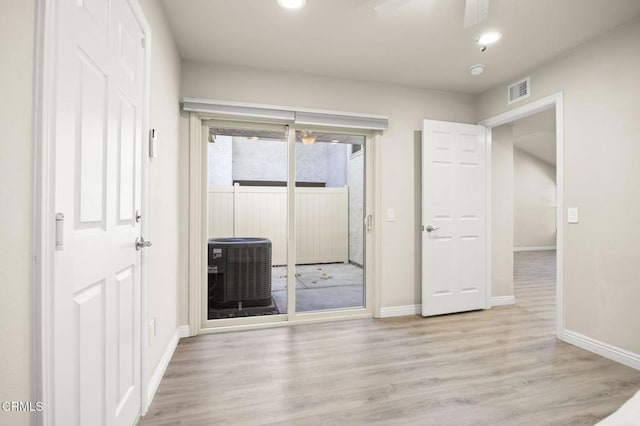 interior space with access to exterior and light wood-type flooring