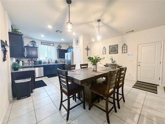 tiled dining room featuring sink