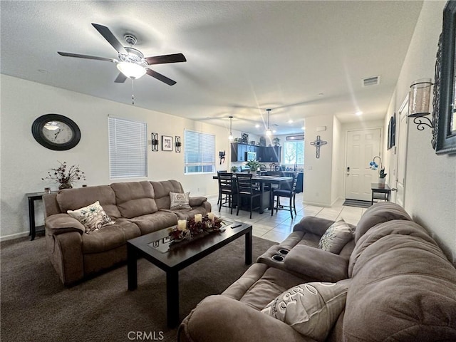 tiled living room with ceiling fan