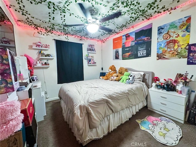 bedroom with ceiling fan and dark colored carpet