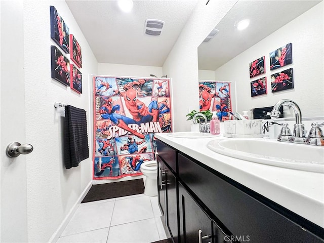 bathroom with vanity, walk in shower, tile patterned floors, and toilet