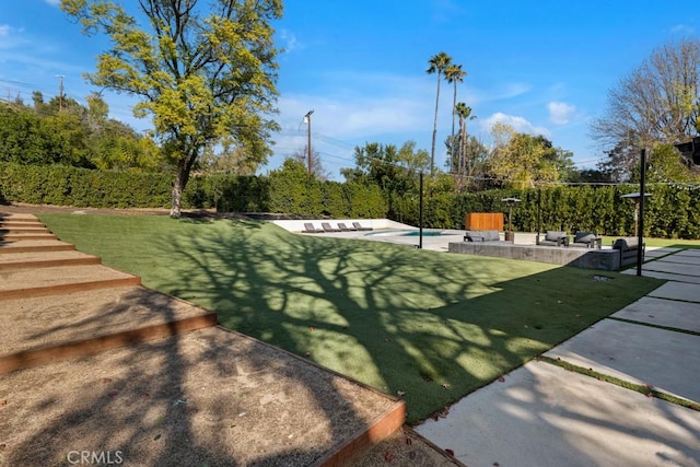 view of community with a lawn, outdoor lounge area, and a patio