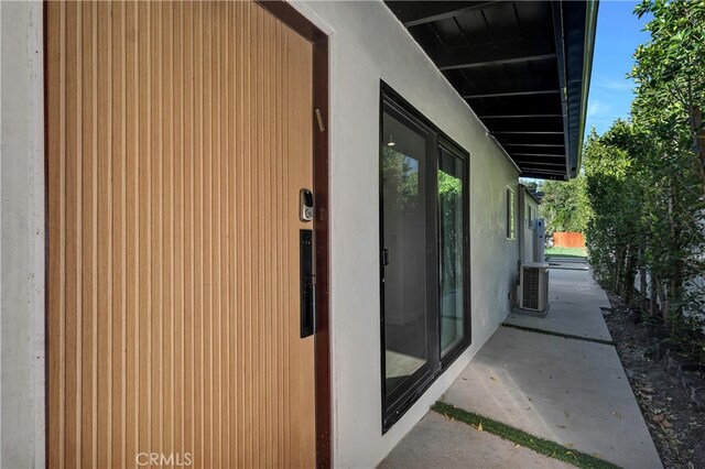 view of side of home with central AC unit