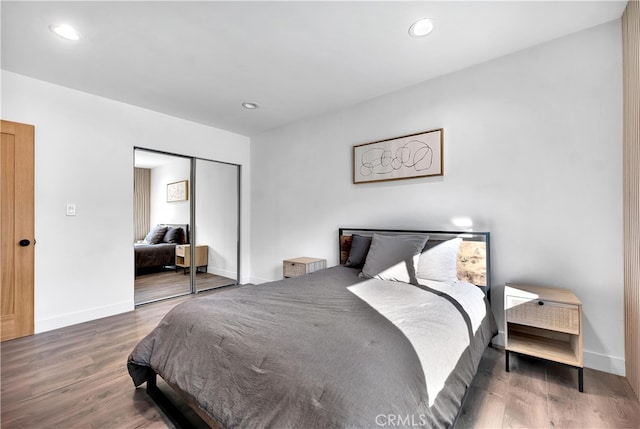 bedroom featuring dark hardwood / wood-style flooring and a closet