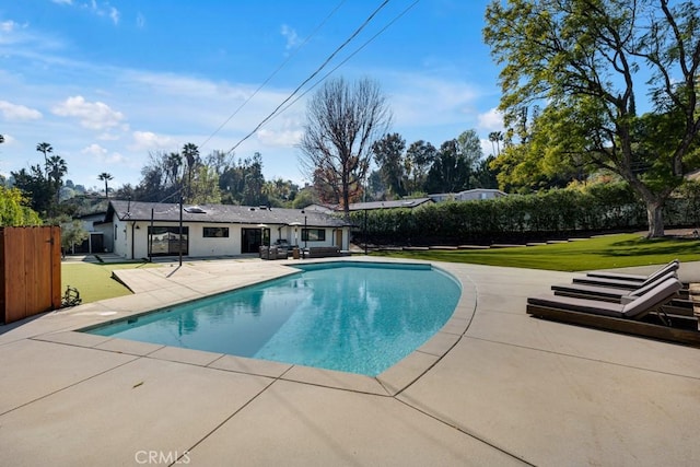 view of swimming pool with a patio and a lawn