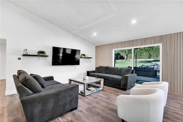 living room featuring vaulted ceiling and hardwood / wood-style floors