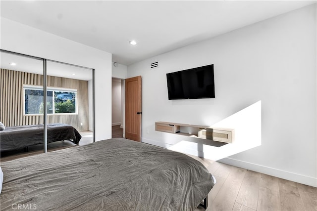 bedroom with hardwood / wood-style floors and a closet