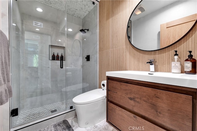 bathroom with vanity, a shower with shower door, and toilet