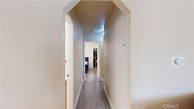 corridor with wood-type flooring