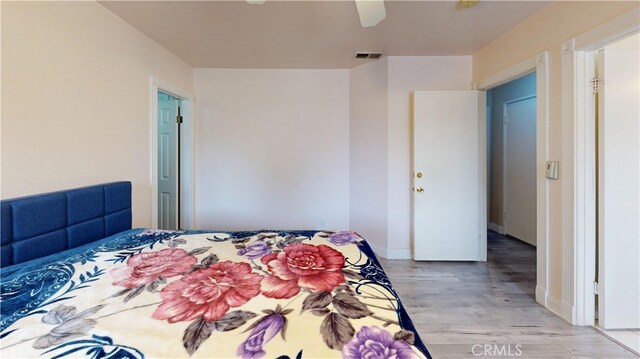 bedroom featuring ceiling fan, light hardwood / wood-style floors, and a closet