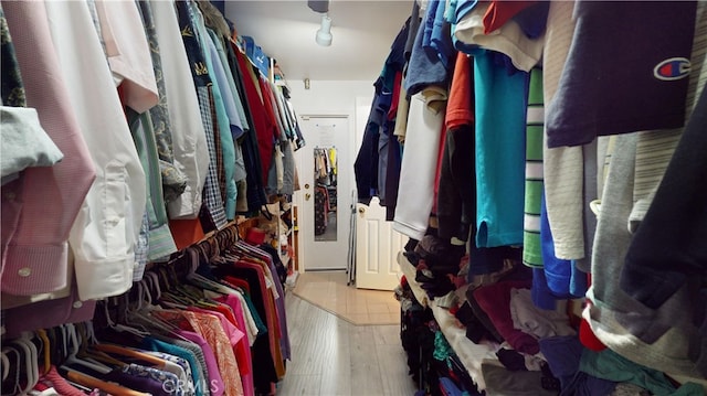 spacious closet with light hardwood / wood-style flooring