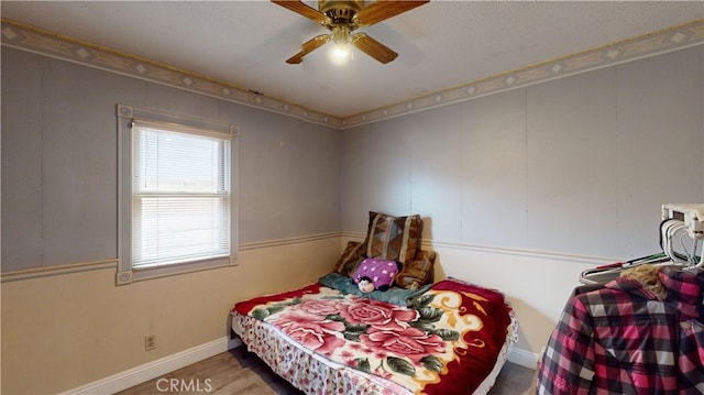 bedroom with ceiling fan and hardwood / wood-style flooring