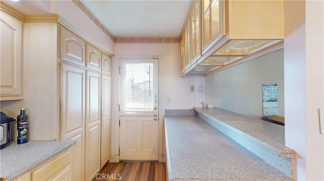 interior space with light brown cabinets and light hardwood / wood-style flooring