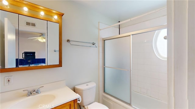 full bathroom featuring vanity, shower / bath combination with glass door, ceiling fan, and toilet