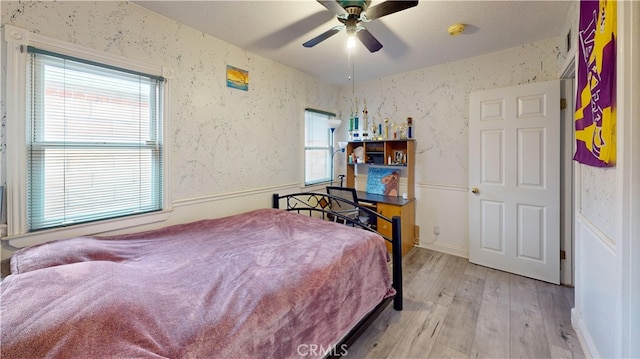 bedroom with ceiling fan and light hardwood / wood-style floors