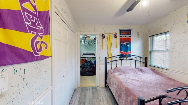 bedroom featuring hardwood / wood-style floors, a closet, and ceiling fan