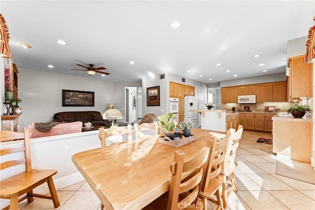 tiled dining room featuring ceiling fan