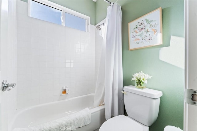 bathroom with toilet and shower / bathtub combination with curtain