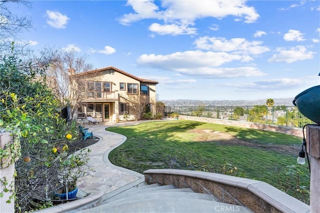 view of yard featuring a patio area and a balcony