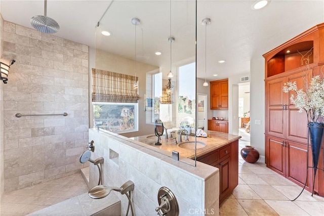 kitchen featuring sink, pendant lighting, and light tile patterned floors