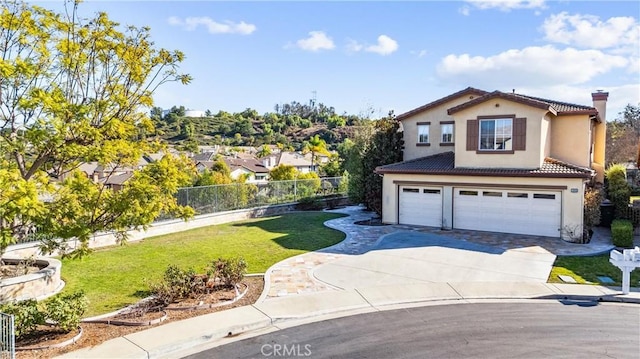 view of front of house with a garage and a front lawn