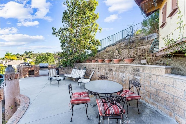 view of patio / terrace featuring exterior kitchen and a grill