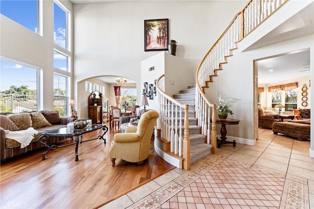 stairway with a high ceiling and tile patterned flooring