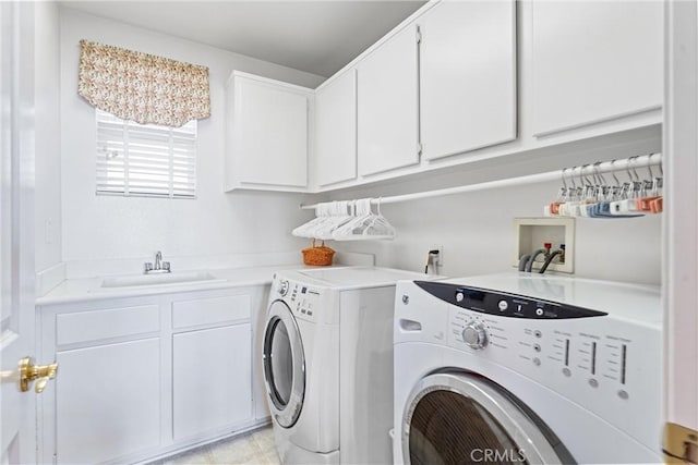 washroom featuring sink, separate washer and dryer, and cabinets