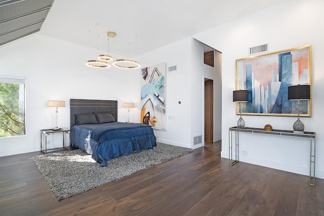 bedroom with dark hardwood / wood-style flooring and lofted ceiling