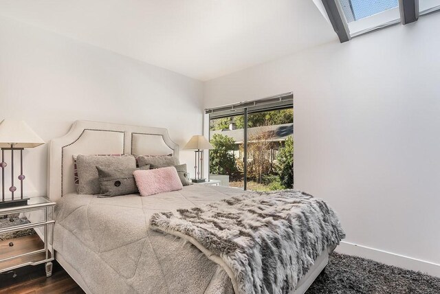 bedroom featuring hardwood / wood-style flooring and access to exterior