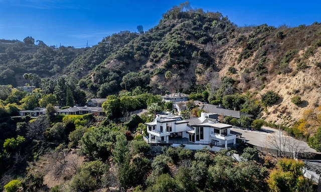 birds eye view of property featuring a wooded view