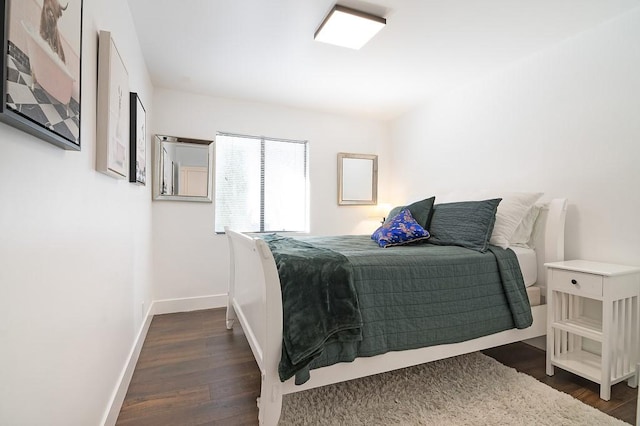 bedroom with dark hardwood / wood-style floors