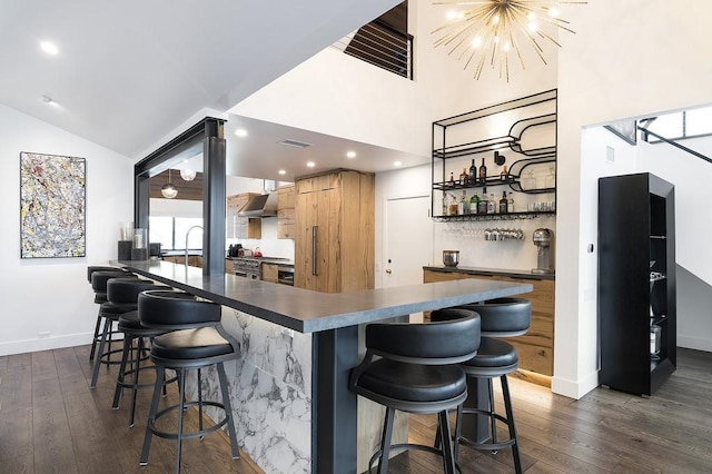 kitchen with wall chimney exhaust hood, open shelves, and dark wood-type flooring