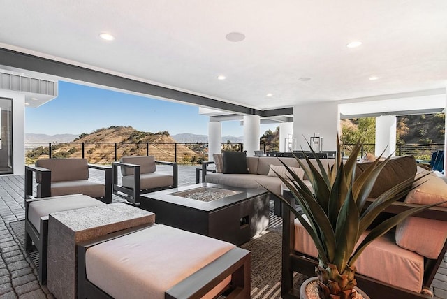 interior space featuring a mountain view and an outdoor living space with a fire pit