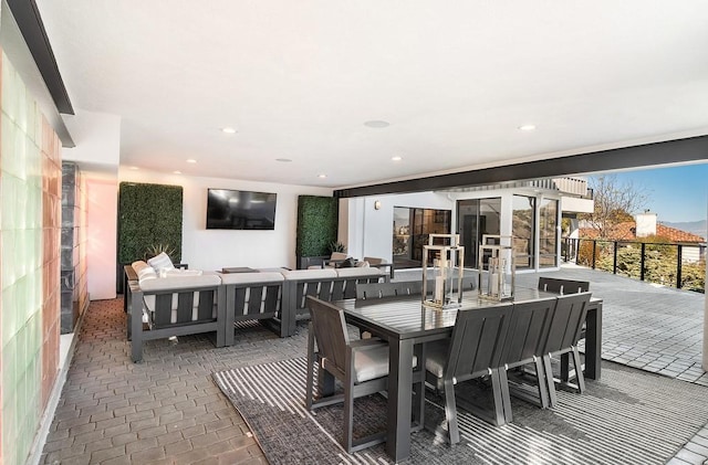 dining room featuring brick floor and recessed lighting