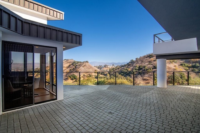 view of patio / terrace featuring a balcony and a mountain view