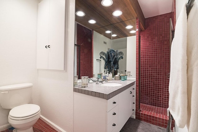 full bathroom featuring toilet, recessed lighting, vanity, baseboards, and a tile shower