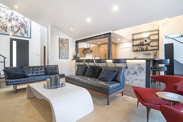 living room with indoor bar and vaulted ceiling