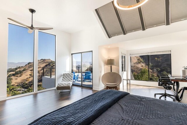 bedroom with multiple windows, access to exterior, dark hardwood / wood-style floors, and ceiling fan