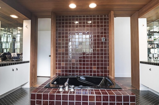 bathroom with vanity, tiled tub, tile patterned floors, and wood ceiling